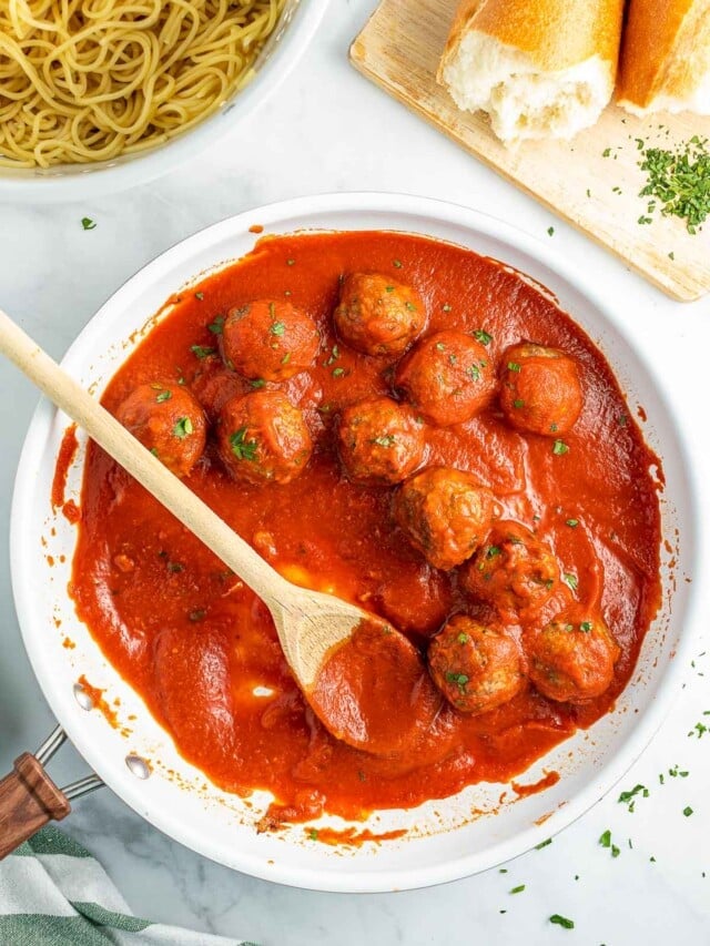 baked Italian Meatballs in skillet with spoon