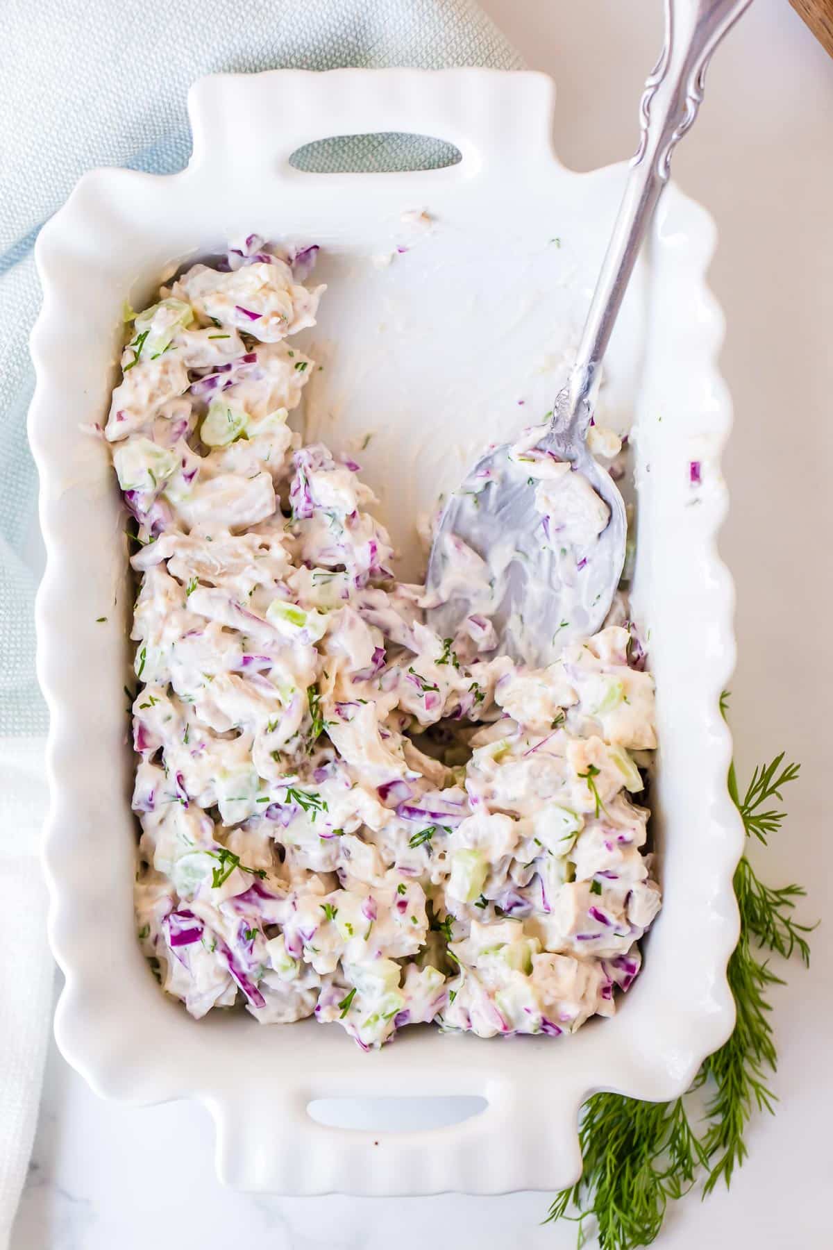 chicken salad in white ruffle edged baking dish