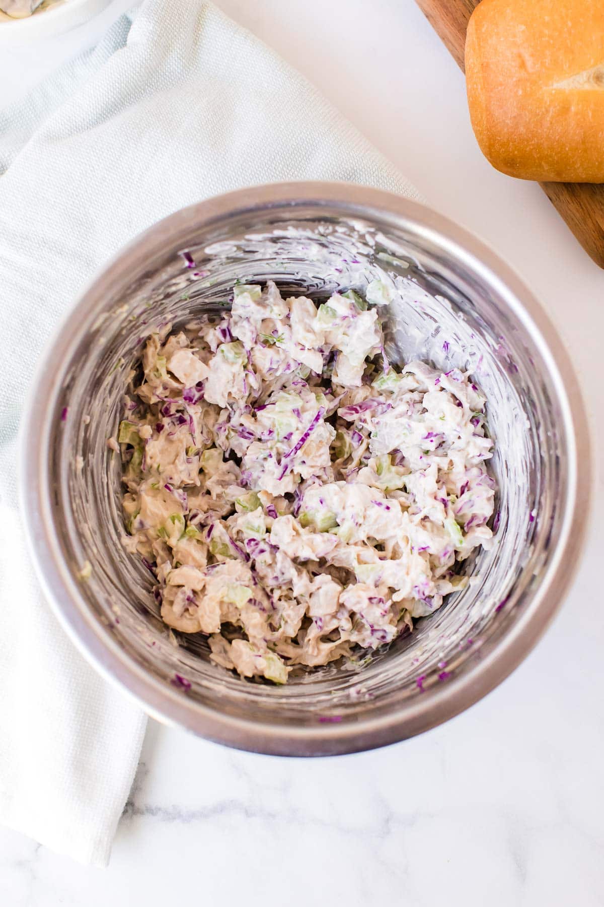 chicken salad recipe mixed together in a metal mixing bowl