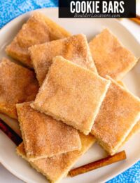 snickerdoodle bars in a pile on white plate